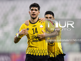 Aria Yousefi (L) of Asepahan SC celebrates with his teammates after scoring a goal during the AFC Champions League Two Group A football matc...