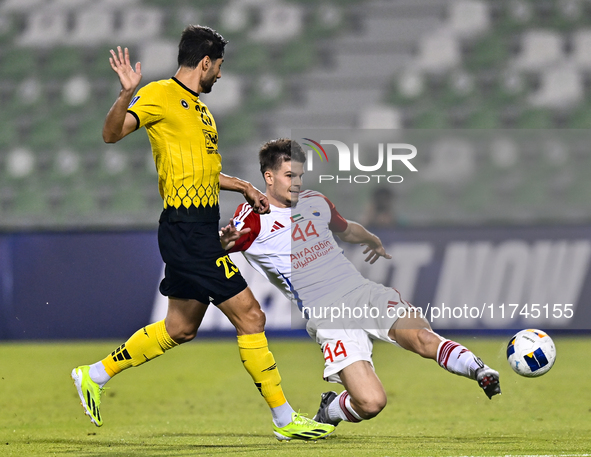 Mehdi Mohebi of Asepahan SC battles for the ball with David Petrovic of Sharjah FC during the AFC Champions League Two Group A football matc...