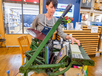 Elysa Voshell, Executive Director of the Minnesota Center for Book Arts, prints postcards using a traditional letterpress for voters to grab...