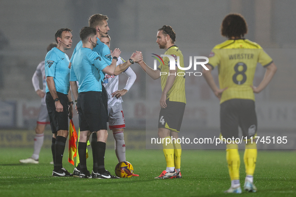 Referee Scott Oldham shakes hands with #4, Elliot Watt of Burton Albion during the Sky Bet League 1 match between Burton Albion and Crawley...