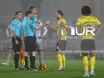 Referee Scott Oldham shakes hands with #4, Elliot Watt of Burton Albion during the Sky Bet League 1 match between Burton Albion and Crawley...