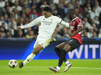 Jude Bellingham central midfield of Real Madrid and England shooting to goal front Fikayo Tomori centre-back of AC Milan and England during...