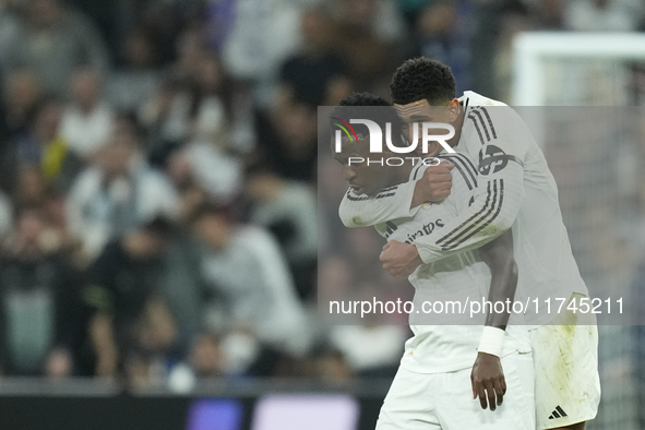 Vinicius Junior left winger of Real Madrid and Brazil celebrates after scoring his sides first goal with Jude Bellingham central midfield of...