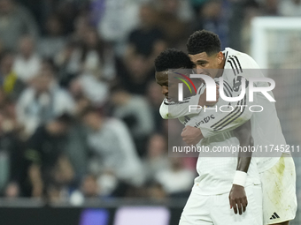 Vinicius Junior left winger of Real Madrid and Brazil celebrates after scoring his sides first goal with Jude Bellingham central midfield of...