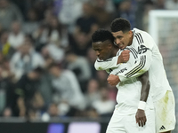 Vinicius Junior left winger of Real Madrid and Brazil celebrates after scoring his sides first goal with Jude Bellingham central midfield of...