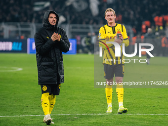 Julian Brandt and Marcel Sabitzer of Borussia Dortmund greet fans after winning the UEFA Champions League 2024/25 League Phase MD4 soccer ma...