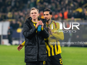 Emre Can and Maximilian Beier of Borussia Dortmund greet fans after winning the UEFA Champions League 2024/25 League Phase MD4 soccer match...