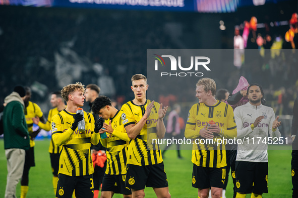 Cole Campbell, Nico Schlotterbeck, and Julian Brandt of Borussia Dortmund greet fans after winning the UEFA Champions League 2024/25 League...