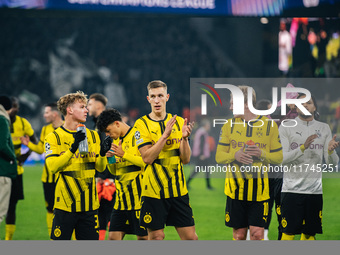 Cole Campbell, Nico Schlotterbeck, and Julian Brandt of Borussia Dortmund greet fans after winning the UEFA Champions League 2024/25 League...