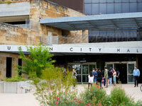 Voters wait in line outside the polling place at Austin City Hall. Voters in the Texas Capital meet with short lines at most polling places...