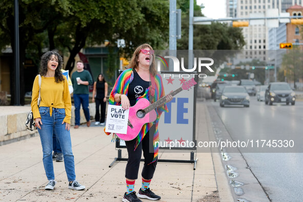 A musician sings to passersby outside the polling place at the Austin City Hall. Voters in the Texas capital meet short lines at most pollin...