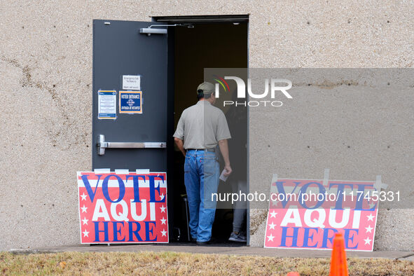 Voters wait in line outside the polling place at a public library in South Austin, Texas, United States, on November 5, 2024. Voters in the...