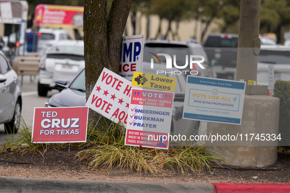 Signs greet voters outside a polling place in suburban Austin, Texas, on the morning of Election Day, as poll-goers meet with short lines at...