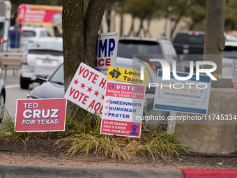 Signs greet voters outside a polling place in suburban Austin, Texas, on the morning of Election Day, as poll-goers meet with short lines at...