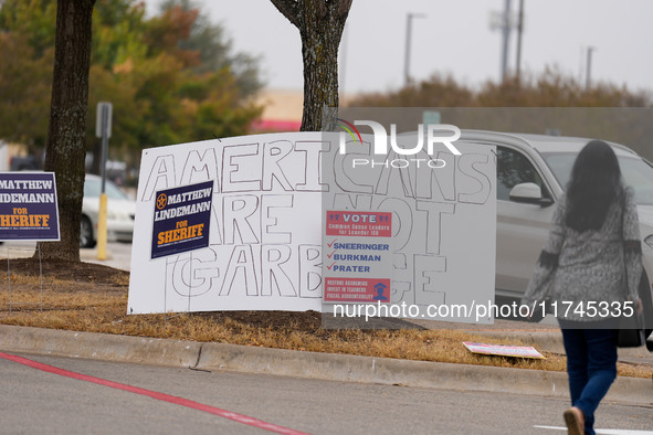 Signs greet voters outside a polling place in suburban Austin, Texas, on the morning of Election Day, as poll-goers meet with short lines at...