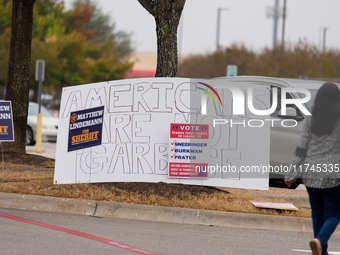 Signs greet voters outside a polling place in suburban Austin, Texas, on the morning of Election Day, as poll-goers meet with short lines at...