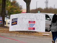 Signs greet voters outside a polling place in suburban Austin, Texas, on the morning of Election Day, as poll-goers meet with short lines at...