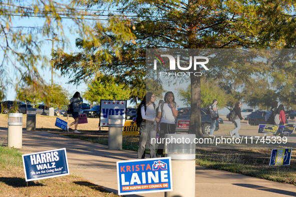 Voters head to the entrance of a polling place in suburban Austin, Texas, on November 5, 2024, in the final hours of voting. Voters across t...