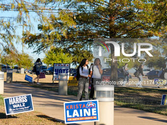 Voters head to the entrance of a polling place in suburban Austin, Texas, on November 5, 2024, in the final hours of voting. Voters across t...