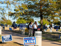 Voters head to the entrance of a polling place in suburban Austin, Texas, on November 5, 2024, in the final hours of voting. Voters across t...