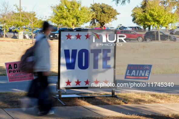 Voters head to the entrance of a polling place in suburban Austin, Texas, on November 5, 2024, in the final hours of voting. Voters across t...