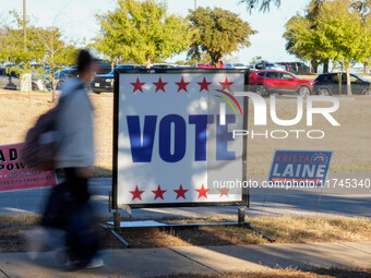 Voters head to the entrance of a polling place in suburban Austin, Texas, on November 5, 2024, in the final hours of voting. Voters across t...