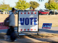 Voters head to the entrance of a polling place in suburban Austin, Texas, on November 5, 2024, in the final hours of voting. Voters across t...