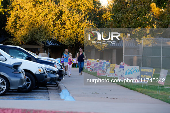 A voter leaves a polling place with her children in suburban Austin, Texas, on November 5, 2024. Voters across the state capital area encoun...