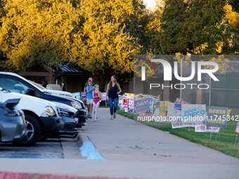 A voter leaves a polling place with her children in suburban Austin, Texas, on November 5, 2024. Voters across the state capital area encoun...