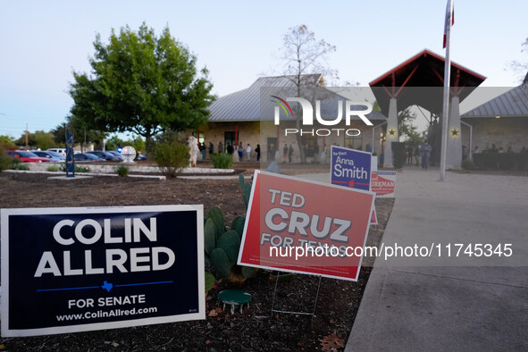 Voters line up outside a polling place in suburban Austin, Texas, on November 5, 2024, in the final hour of voting. Voters across the state...