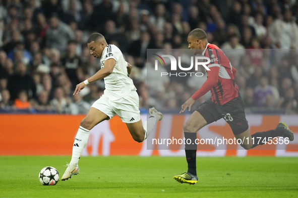 Kylian Mbappe centre-forward of Real Madrid and France and Malick Thiaw centre-back of AC Milan and Germany compete for the ball during the...