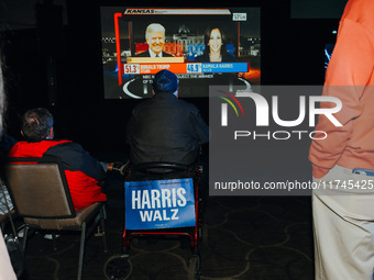 Attendees watch television coverage of the United States 2024 election at the Minnesota DFL Election Night event at the InterContinental Hot...