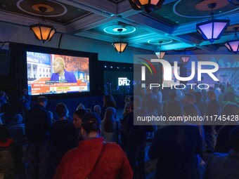 Attendees watch television coverage of the United States 2024 election at the Minnesota DFL Election Night event at the InterContinental Hot...