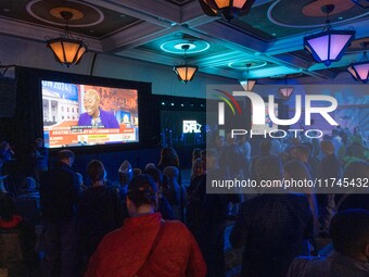 Attendees watch television coverage of the United States 2024 election at the Minnesota DFL Election Night event at the InterContinental Hot...