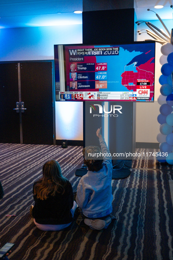 Young attendees watch television coverage of the United States 2024 election at the Minnesota DFL Election Night event at the InterContinent...