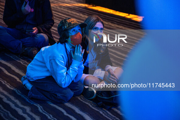 Young attendees watch television coverage of the United States 2024 election at the Minnesota DFL Election Night event at the InterContinent...