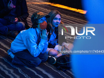 Young attendees watch television coverage of the United States 2024 election at the Minnesota DFL Election Night event at the InterContinent...