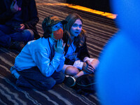 Young attendees watch television coverage of the United States 2024 election at the Minnesota DFL Election Night event at the InterContinent...