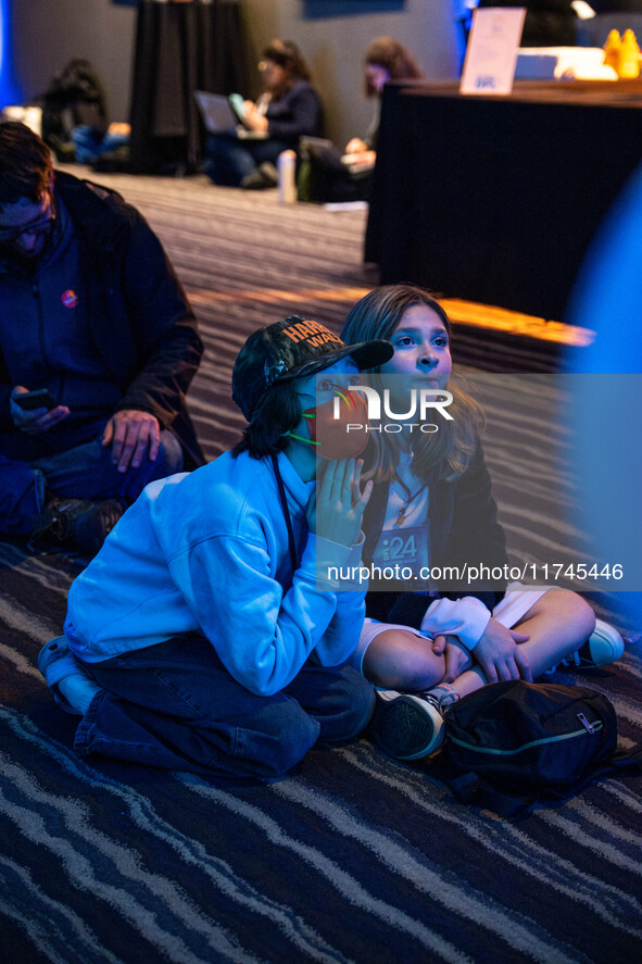 Young attendees watch television coverage of the United States 2024 election at the Minnesota DFL Election Night event at the InterContinent...