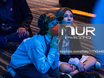 Young attendees watch television coverage of the United States 2024 election at the Minnesota DFL Election Night event at the InterContinent...