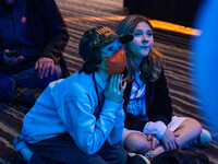 Young attendees watch television coverage of the United States 2024 election at the Minnesota DFL Election Night event at the InterContinent...