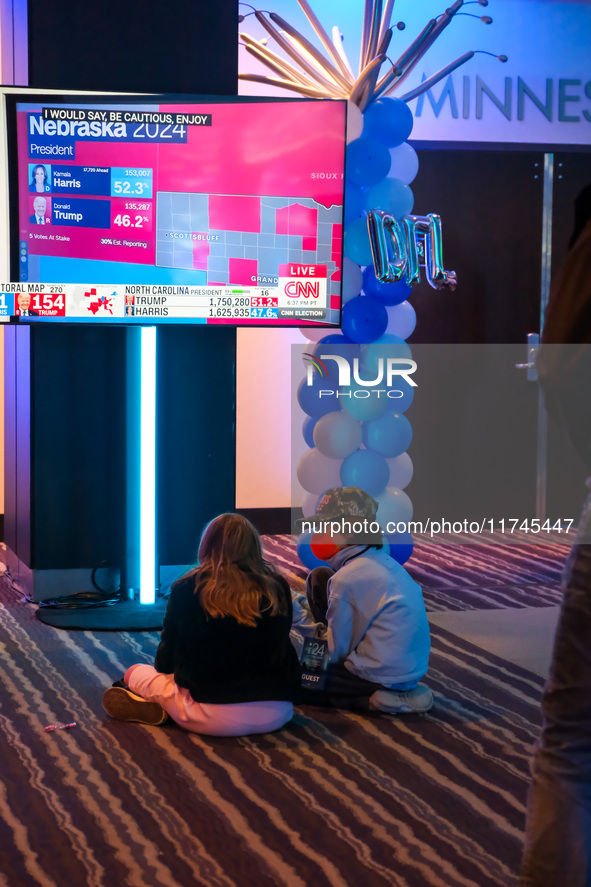 Young attendees watch television coverage of the United States 2024 election at the Minnesota DFL Election Night event at the InterContinent...