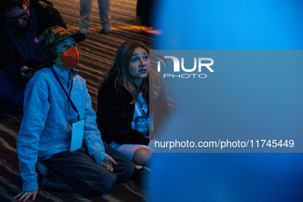 Young attendees watch television coverage of the United States 2024 election at the Minnesota DFL Election Night event at the InterContinent...