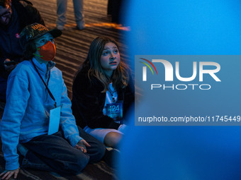 Young attendees watch television coverage of the United States 2024 election at the Minnesota DFL Election Night event at the InterContinent...