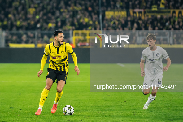 Ramy Bensebaini of Borussia Dortmund and William Boving of SK Sturm Graz play during the UEFA Champions League 2024/25 League Phase MD4 socc...