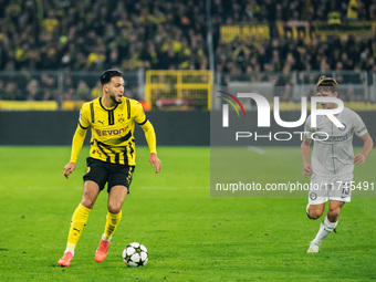 Ramy Bensebaini of Borussia Dortmund and William Boving of SK Sturm Graz play during the UEFA Champions League 2024/25 League Phase MD4 socc...