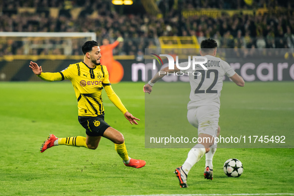 Ramy Bensebaini of Borussia Dortmund and Jusuf Gazibegovic of SK Sturm Graz are in action during the UEFA Champions League 2024/25 League Ph...