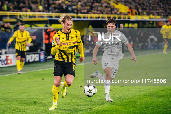 Julian Brandt of Borussia Dortmund and William Boving of SK Sturm Graz play during the UEFA Champions League 2024/25 League Phase MD4 soccer...