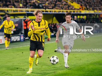 Julian Brandt of Borussia Dortmund and William Boving of SK Sturm Graz play during the UEFA Champions League 2024/25 League Phase MD4 soccer...