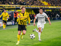 Julian Brandt of Borussia Dortmund and William Boving of SK Sturm Graz play during the UEFA Champions League 2024/25 League Phase MD4 soccer...